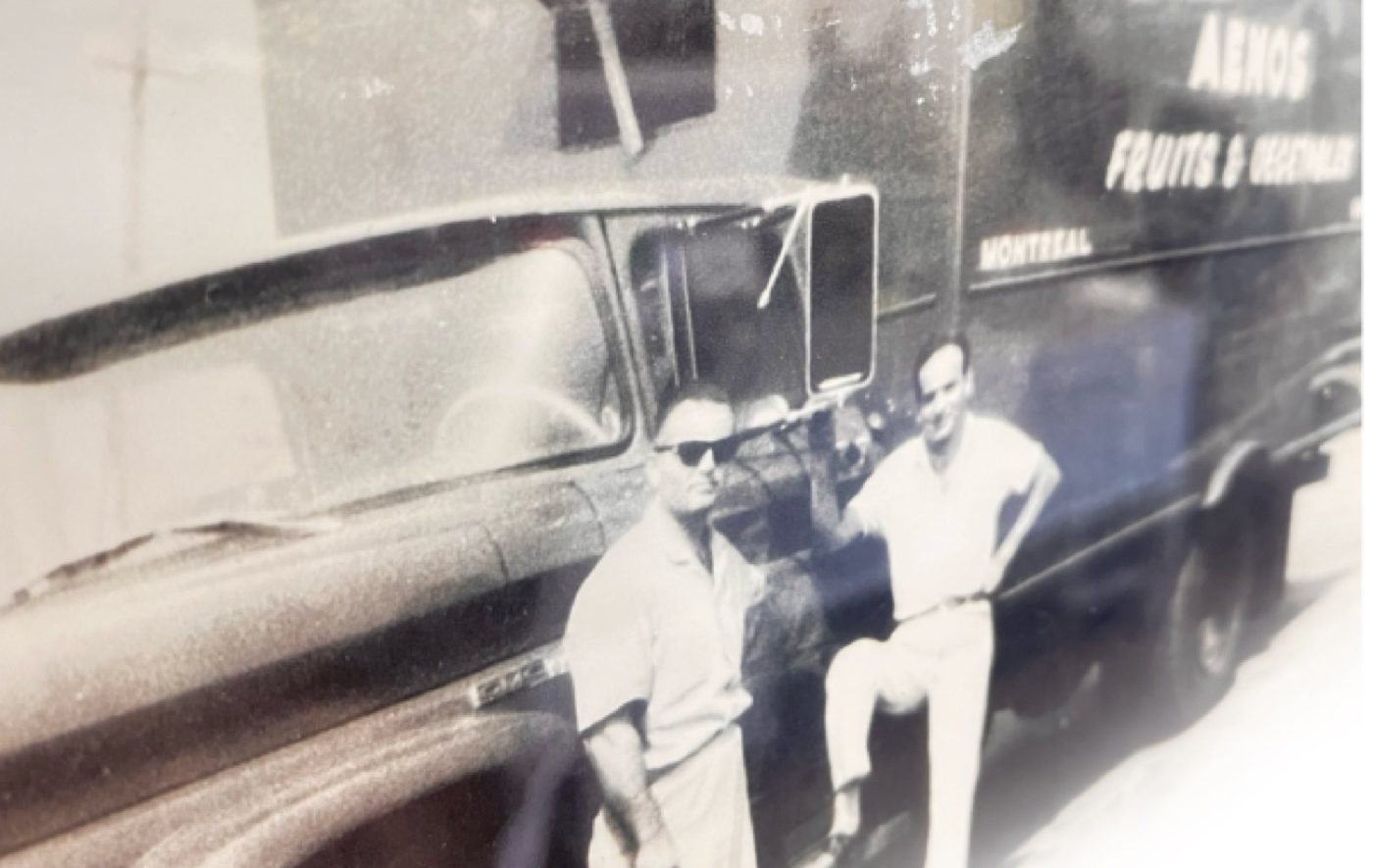 Two men beside an early Aenos delivery truck lettered "Aenos Fruits & Vegetables, Montreal"